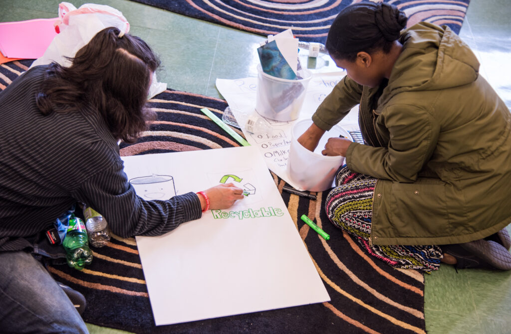 Students at Benjamin Franklin High School in Baltimore making posters about recycling for a community event (Photo by Jaclin Paul)